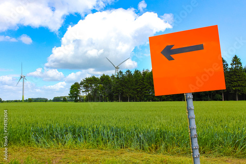 Orange sign with arrow for detour in nature in Germany. photo