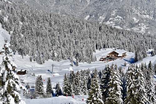 Ski resort Courchevel by winter, by a restaurant on the slopes between snowy trees. 