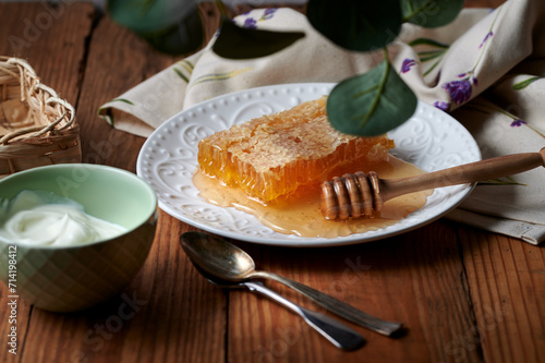 Rustic dinner table with delicious natural honey with honeycomb and yoghurt