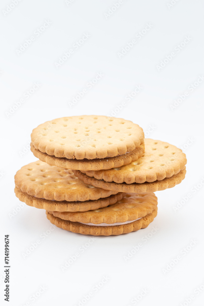 Stacked sandwich biscuits with pink cream filling. Sandwich cookies lie one on top of the other Stacked sandwich biscuits with pink cream filling. Sandwich cookies lie one on top of the other