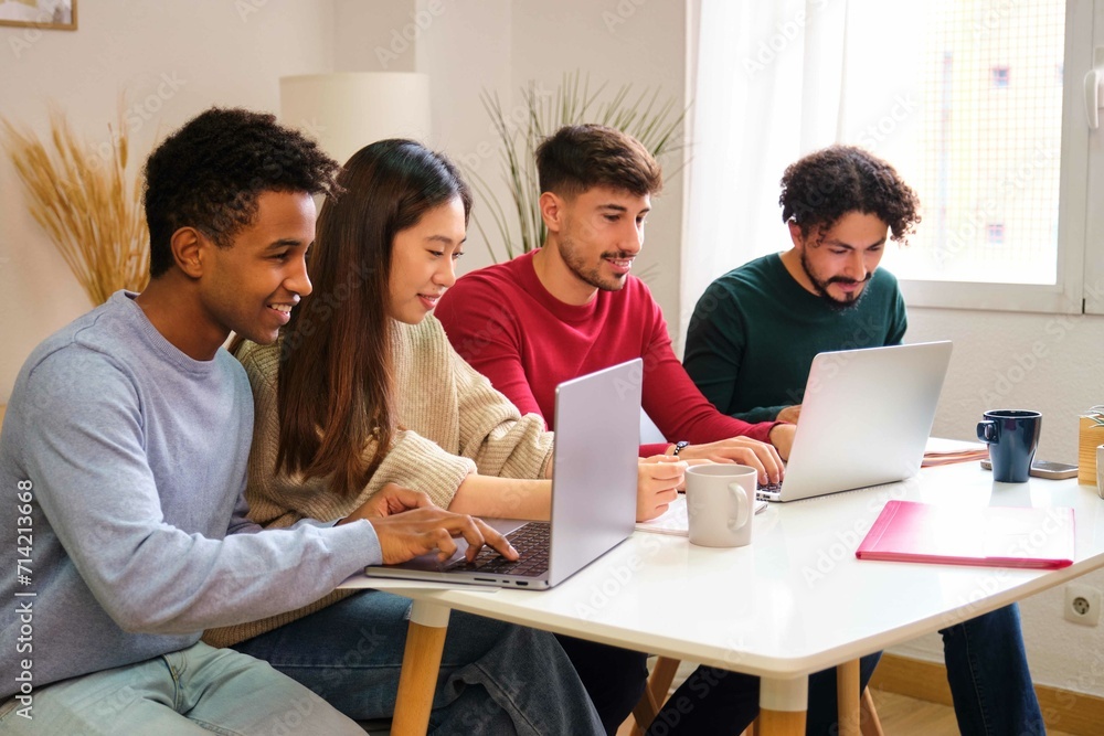 Group of diverse university colleagues studying together at shared students house. Group of diverse university colleagues studying together at shared students house.