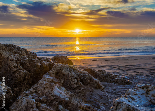 Golden sunrise over a rugged coastline, perfect for inspirational themes, travel promotion, and natural landscape photography.