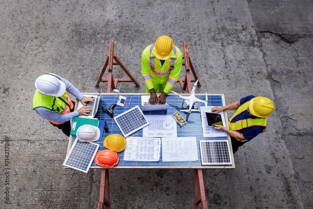custom made wallpaper toronto digitalForeman or worker work at Container cargo site. Architectural engineer working, meeting, planning with blueprint, Solar photovoltaic equipment and wind turbine