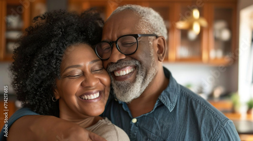Happy Mature African American Couple Embracing and Smiling in Their Home