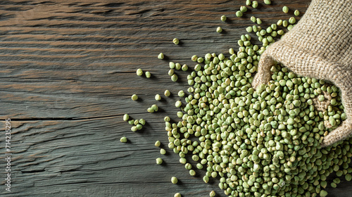 a woven bag with green buckwheat is scattered on a wooden table photo