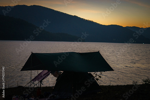 Camping sunset over the sea © keerati