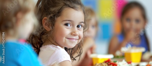 Children in day care center eating nutritious meals. photo