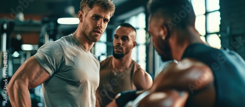 Men engaging in a friendly muscle battle at the gym, fostering bonding and camaraderie. © 2rogan