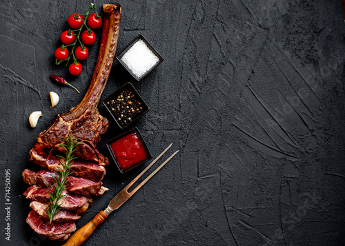 Grilled Tomahawk steak on stone background with copy space for text

