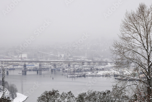 The Ironworkers Memorial Second Narrows Crossing connecting Vancouver to the North Shore in the Burrard Inlet as seen from Capitol Hill during a winter season in Burnaby, British Columbia, Canada photo