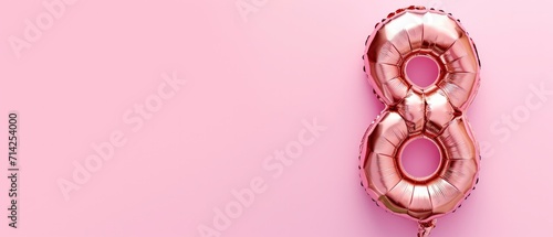Celebration for International Women's Day. Number 8 Shaped Balloon on a Pastel Pink Background. photo