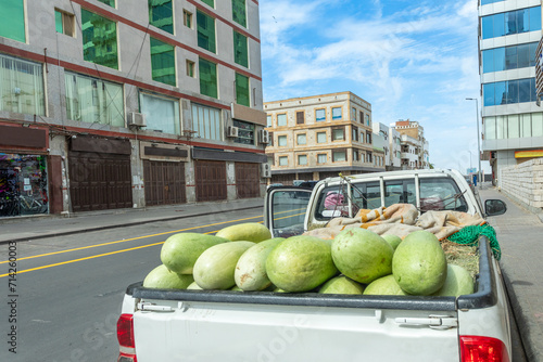 Pickup car full of watermelons on the street of Jeddah downtown central district, Saudi Arabia photo