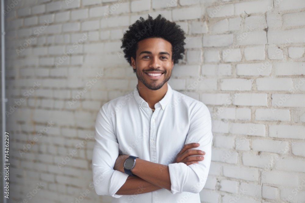 Smiling Afro American man poses against white wall Smiling Afro American man poses against white wall