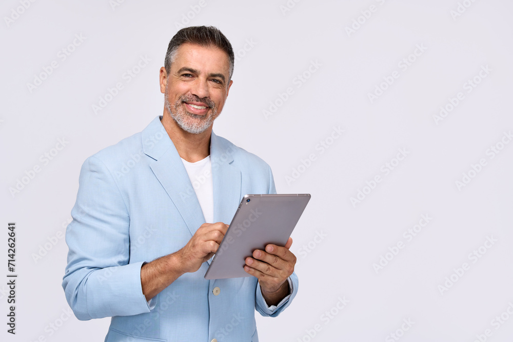 Happy middle aged business man ceo wearing suit standing isolated on white using digital tablet. Smiling mature businessman professional executive manager looking at camera holding device. Portrait