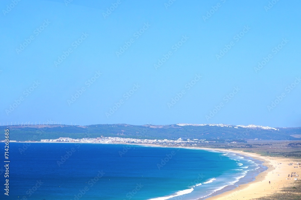 view from the moutains over the beautiful endless sandy beach between Zahara de los Atunes and Barbate with Vejer de la Frontera at the hilltop, Costa de la Luz, Andalusia, Spain