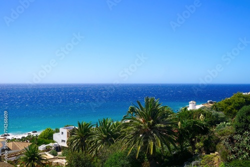 view over palms, exotic plans and villas towards the Atlantic Ocean, Playa Los Alemanes, Atlanterra, Faro de Camarinal, Costa de la Luz, Atlanterra, Andalusia, Spain