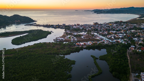 Barra de Navidad Aerial of Jalisco Mexico resort beach town with pacific coastline ocean view at sunset and lake lagoon © Michele