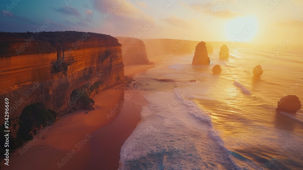 AERIAL: Spectacular drone point of view of the famous 12 Apostles beach in Australia on a sunny summer evening. Golden sunshine illuminates the cliffs and other rock formations on coast of Australia. - obrazy, fototapety, plakaty 