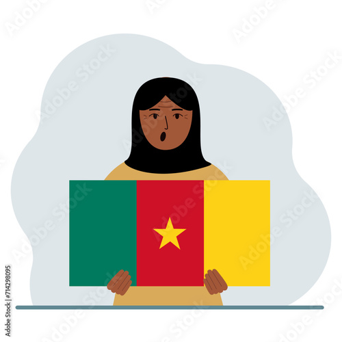 A woman holds the flag of Cameroon in his hands. The concept of demonstration, national holiday or patriotism. Nationality.