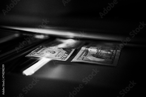 Using a copy machine to print forgery currency.  photo