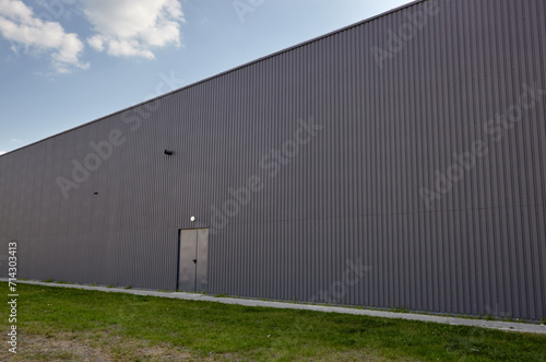 Wallpaper Mural Corrugated steel warehouse or factory industrial building against blue sky. Architecture. Metal texture Torontodigital.ca