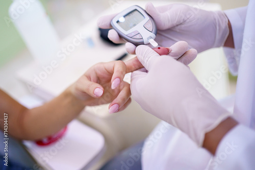 Crop doctor checking sugar level of patient in clinic