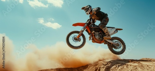 a motorcyclist doing stunts while on his dirt bike
