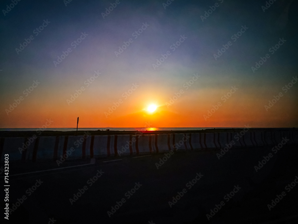 Sunset over ocean. Orange and blue sky with sunset over ocean. 