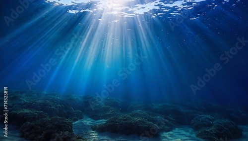 abstract image of tropical underwater dark blue deep ocean wide nature background with rays of sunlight