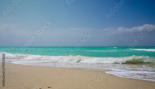 closeup of sandy beach with turquoise sea and sky background high quality photo