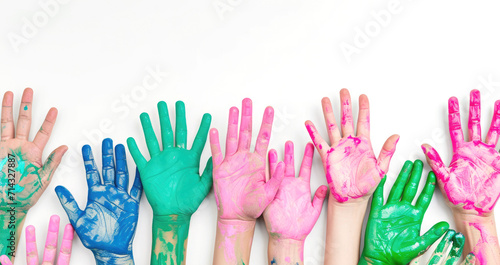 Multiple children's hands covered in colorful paints, raised high to show support and raise awareness for Rare Disease Day..