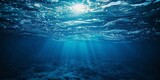 Dark blue ocean surface seen from underwater, horizontal wide background.