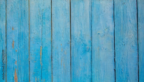 light blue old wooden background of boards old worn cracked paint bright saturated color