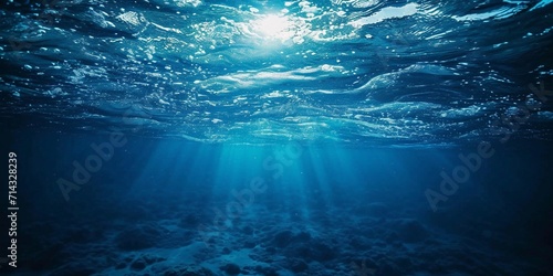 Dark blue ocean surface seen from underwater, horizontal wide background.