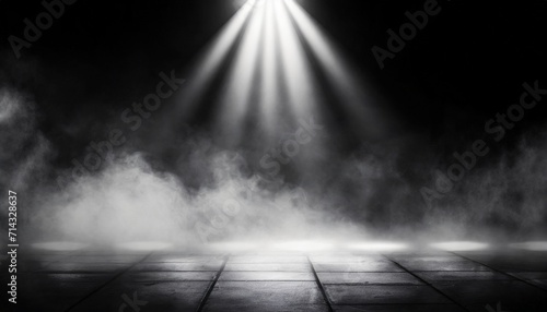 empty space of studio dark room with spot lighting and fog or mist on concrete floor in black background