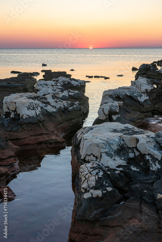 Rocks on sea in sunset