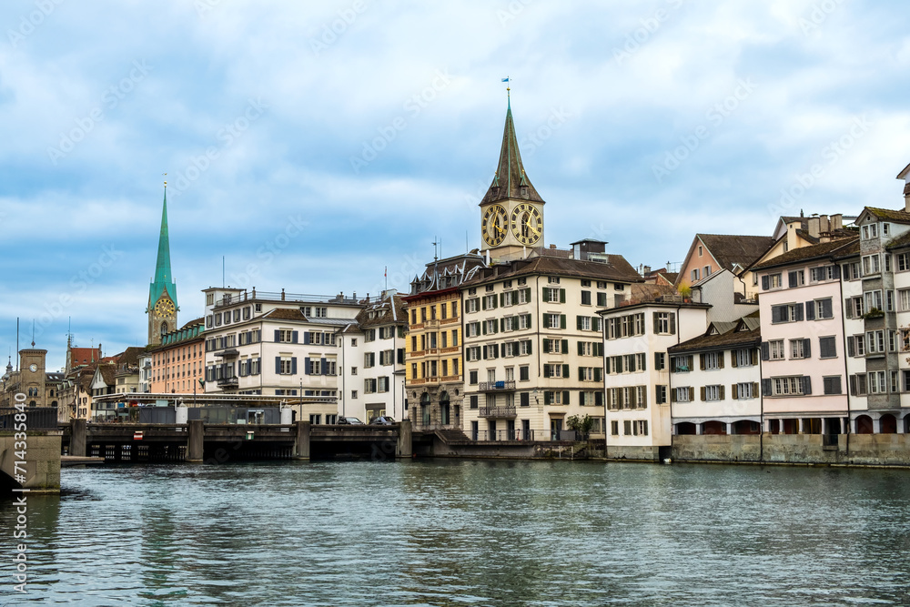 Zurich city center, Switzerland. Zuerich old town with famous Fraumunster and St. Peter Church on bank of river Limmat in winter