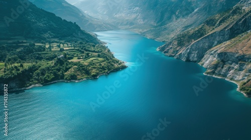  an aerial view of a lake surrounded by mountains and a valley in the middle of the picture is a bird's - eye view of the water, with a bird's - eye view.