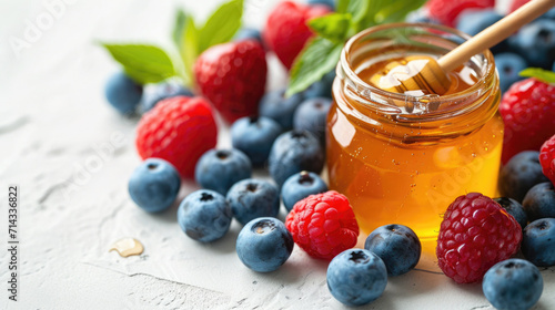 Organic honey and fresh berries setup on a white background, illustrating natural sweeteners and antioxidants