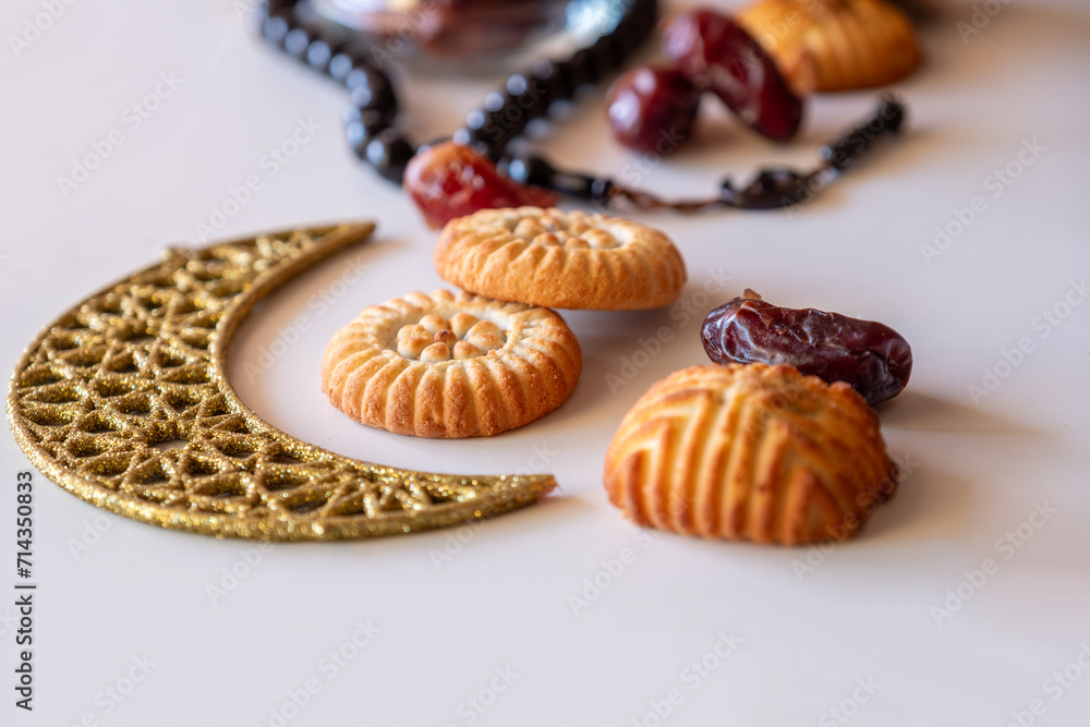 Variety of semolina maamoul cookies displayed with crescent ,star and Ramadan decorations. Traditional Arabic sweets for Eid al Adha and Eid al Fitr celebrations. Variety of semolina maamoul cookies displayed with crescent ,star and Ramadan decorations. Traditional Arabic sweets for Eid al Adha and Eid al Fitr celebrations.