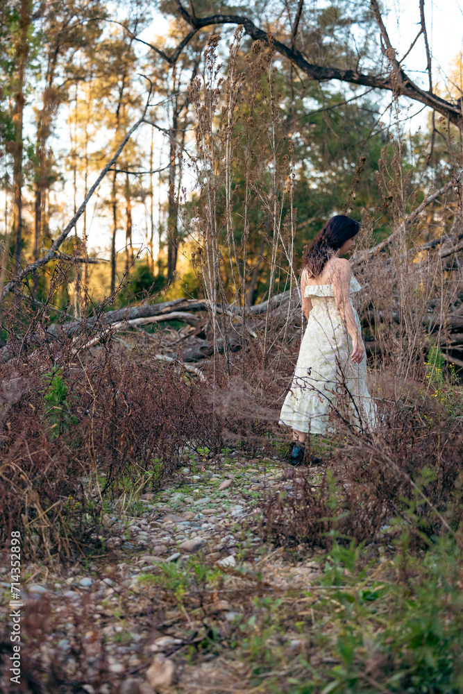 Woman wearing long dress walking in the Australian bush Woman wearing long dress walking in the Australian bush