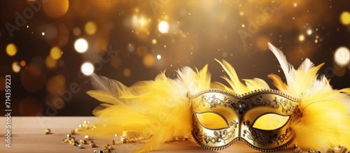 Luxury carnival mask with yellow feathers on gold blurred background. AI generated image photo