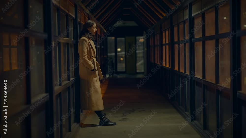 Sad Woman Thinking Hopeless and Lonely Inside Urban Hallway at Night Light Sad Woman Thinking Hopeless and Lonely Inside Urban Hallway at Night Light