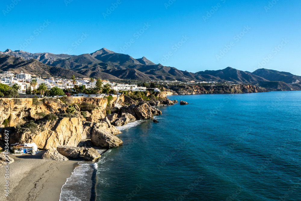 Obraz premium View of the beautiful city of Nerja. Andalusia, Spain. Panorama of the sea, city and mountains.
