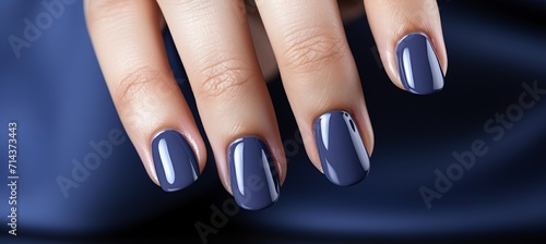 Elegant navy blue gel manicure for french manicurea female hand model showcasing stunning nail art.