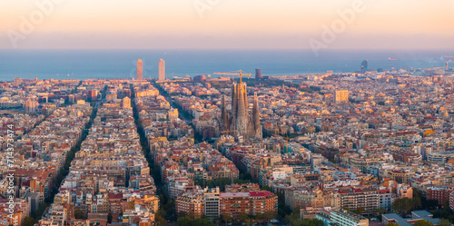 Aerial view of Barcelona City Skyline and Sagrada Familia Cathedral at sunset. Residential famous urban grid of Catalonia. Beautiful panorama of Barcelona.