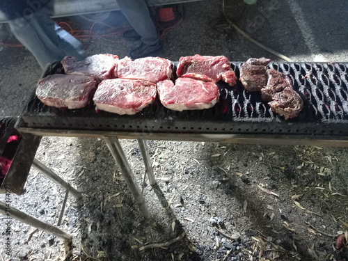 Steaks on a barbecue in the process of cooking 