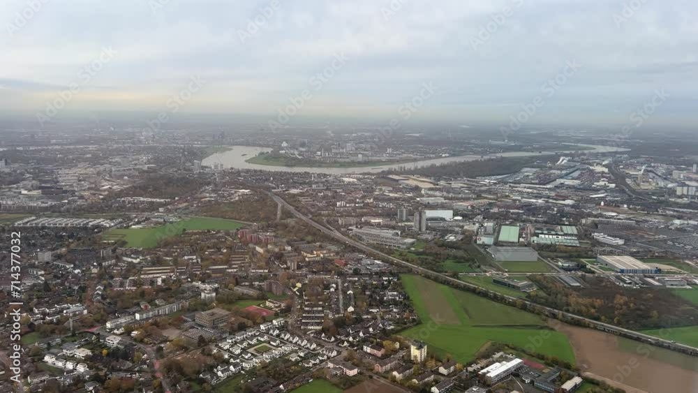 Beautiful aerial view of a plane flying parallel to the river Rhine, city of Düsseldorf by day. Handheld panning wide bird's eye view shot from an aeroplane, background in focus. Real time after, 4K Beautiful aerial view of a plane flying parallel to the river Rhine, city of Düsseldorf by day. Handheld panning wide bird's eye view shot from an aeroplane, background in focus. Real time after, 4K
