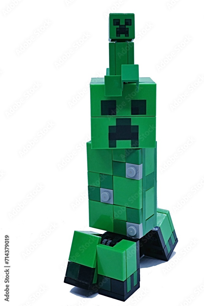 Naklejka premium LEGO Minecraft small and big figure of explosive green mob called Creeper, small one sitting on head of big one.