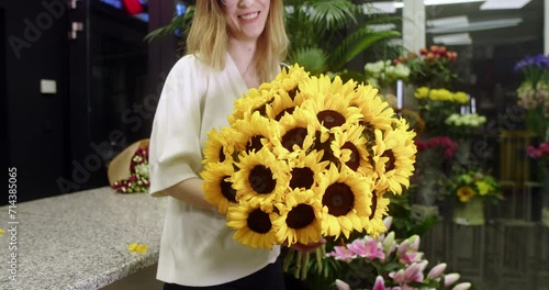  florist in a flower store shows sunflowers